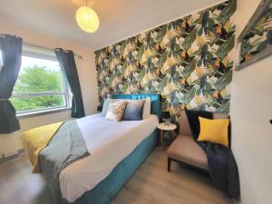 a bedroom with a bed and a chair with a wallpaper at Business & Familes Three Bedrooms By Sensational Stay Short Lets & Serviced Accommodation, Aberdeen With Balcony & Free Parking in Aberdeen