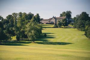 a view of a golf course with a house at Edenmore House in Craigavon