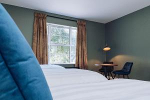 a bedroom with two beds and a window at Edenmore House in Craigavon