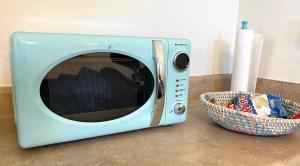 a blue microwave sitting next to a basket of candy at Casita Alkie in Litchfield Park