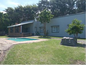 a house with a swimming pool in the yard at Seagulls Nest in Port Edward