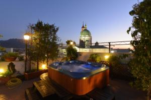 a hot tub on the roof of a building at Hotel Palma in Pompei