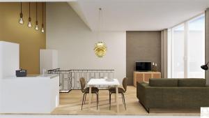 a living room with a table and a couch at Residentie d'Ouwe Kercke in Terneuzen