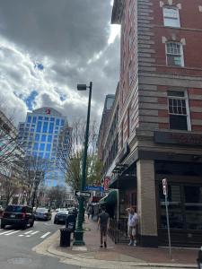 a city street with people walking on the sidewalk at Downtown Norfolk Loft in Norfolk