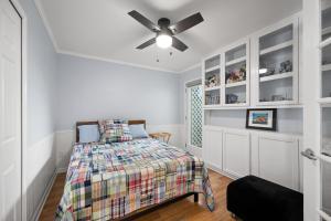 a bedroom with a bed and a ceiling fan at Loggerhead - Lodge in Ponte Vedra Beach