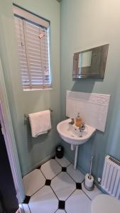 a bathroom with a sink and a mirror at The Farrier's by Spires Accommodation A convenient place to stay for exploring Cannock Chase in Hednesford