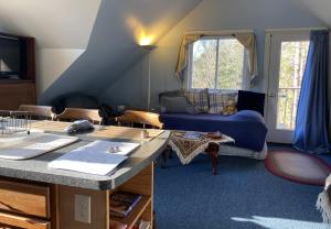 a living room with a couch and a table at Artful Lodging & Retreats in Montpelier
