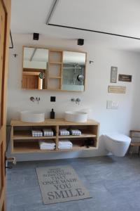 a bathroom with two sinks and a mirror at paclera79 in Santa Maria Val Müstair