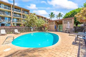 a swimming pool in front of a building at Maui Vista Condo 2410 in Kihei