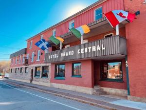 a red building with flags on the side of it at Grand Central Hotel Richmond in Richmond