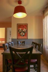 a dining room with a table with chairs and a lamp at Domaine des Roches Hotel & Spa in Briare