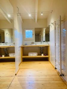 a bathroom with two sinks and a large mirror at Hotel Masia La Palma in Espinavesa
