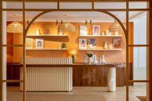 a room with a table and shelves at Grand Hotel d'Orange, BW Signature Collection in Orange