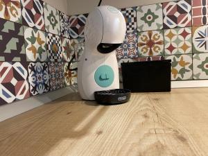 a white robot standing in a room with a laptop at Apartamento Cielo del Norte VUT LE-933 in León