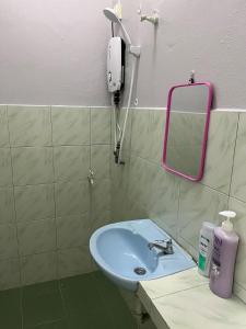 a bathroom with a sink and a phone on the wall at Homestay Malim Nawar in Malim Nawar