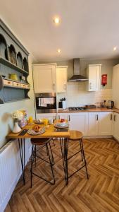 a kitchen with a table with plates of food on it at Worthingtons by Spires Accommodation A cosy and comfortable home from home place to stay in Burton-upon-Trent in Burton upon Trent