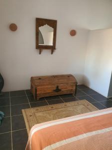 a bedroom with a bed and a mirror on the wall at Dar Chick Yahia Ile De Djerba in Mezrane