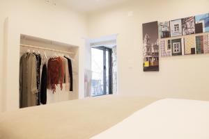 a dressing room with a bed and a mirror at Vila Santa Marinha in Lisbon