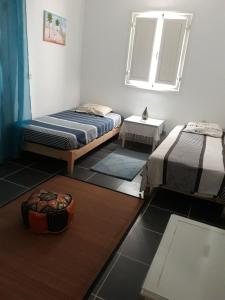 a room with two beds and a mirror at Dar Chick Yahia Ile De Djerba in Mezrane