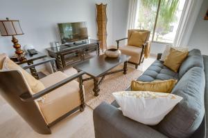 a living room with couches and a tv at Las Terrazas Resort in San Pedro