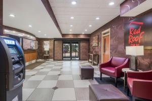 a red rock motel lobby with a red chair and a red rock machine at Red Roof Inn Fairfield in Fairfield