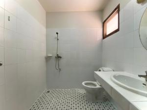 a white bathroom with a sink and a toilet at Mom and Me Resort & Farm in Doi Saket