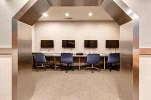a conference room with a long table with chairs and monitors at Powderhorn Lodge 209 in Solitude +25 photos