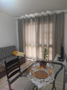 a living room with a glass table and a couch at Apartamento no coração de Porto Alegre in Porto Alegre