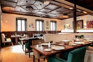 a restaurant with a long wooden table and chairs at Altstadthotel Messerschmitt in Bamberg