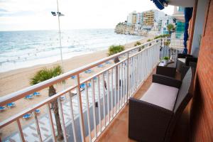 a balcony with a view of the beach and the ocean at SEAFRONT UNBEATABLE LOCATION a in Benidorm