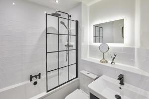 a white bathroom with a toilet and a sink at Host & Stay - The Eskape in Whitby