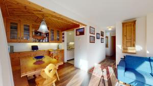 a kitchen and living room with a blue couch at Truoch in Samedan