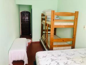 a bedroom with a bunk bed and a ladder at Casa Gris in Praia Grande