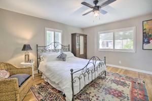 a bedroom with a bed and a ceiling fan at Enchanting Reno Retreat with Deck Walk to Midtown! in Reno