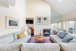 a living room with two couches and a table at South Beach 51 in Glen Arbor