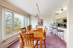 a kitchen and dining room with a wooden table and chairs at South Beach 51 in Glen Arbor