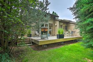 a house with a porch with a wooden deck at Mountain-Modern Unit Golf, Hike, Ski and More! in Bend
