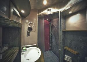 a small bathroom with a sink and a shower at Тhe Bohemian Lodge-entire house with sauna in Veliko Tŭrnovo +34 photos