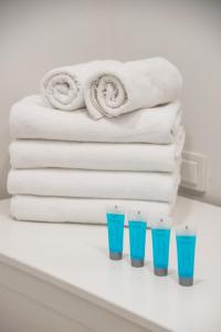 półka z ręcznikami i czterema niebieskimi okularami w obiekcie West Warsaw Contemporary Apartment w Warszawie
