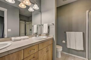 a bathroom with a sink and a toilet and a mirror at Quaint Issaquah Home - Walk to Shops and Dining in Issaquah