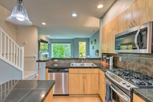 a kitchen with a sink and a stove at Quaint Issaquah Home - Walk to Shops and Dining in Issaquah