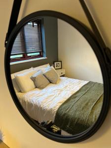 a bedroom with a bed in a mirror at No31 Apartment Cardiff in Cardiff