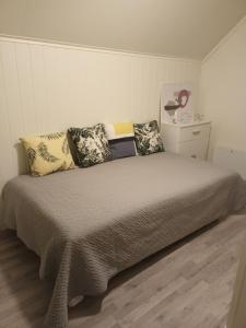 a bedroom with a bed with pillows on it at Olgas apartment in Tromsø