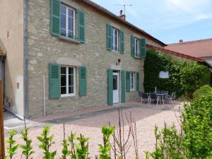 a stone house with green shutters and a patio at Charmante maison rénovée avec jardin clos, 3 chambres, proche sites touristiques et villlage médiéval - FR-1-489-105 in Saint-Bonnet-de-Rochefort