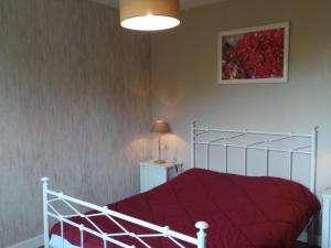 um quarto com uma cama com um edredão vermelho em Gîte Creuzier-le-Neuf, 4 pièces, 6 personnes - FR-1-489-76 em Creuzier-le-Neuf