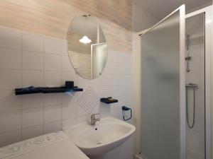 a bathroom with a sink and a mirror and a shower at Gîte Montagne avec Terrasse et Barbecue - Animaux Acceptés - FR-1-489-101 in Ferrières-sur-Sichon