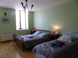 a bedroom with two beds and a couch at Gîte Arfeuilles, 5 pièces, 11 personnes - FR-1-489-280 in Arfeuilles