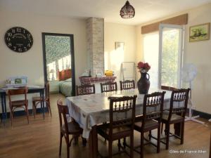 a dining room with a table and chairs at Maison spacieuse avec jardin, proche activités, climatisée, vélos, et lits faits à l'arrivée - FR-1-489-284 in Couleuvre