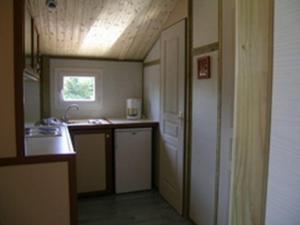 a small kitchen with a sink and a stove at Gîte Échassières, 3 pièces, 5 personnes - FR-1-489-288 in Échassières