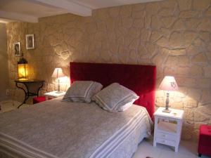 a bedroom with a large bed and two tables with lamps at Grande maison calme avec piscine chauffée en Auvergne - FR-1-489-346 in Saint-Hilaire +13 photos